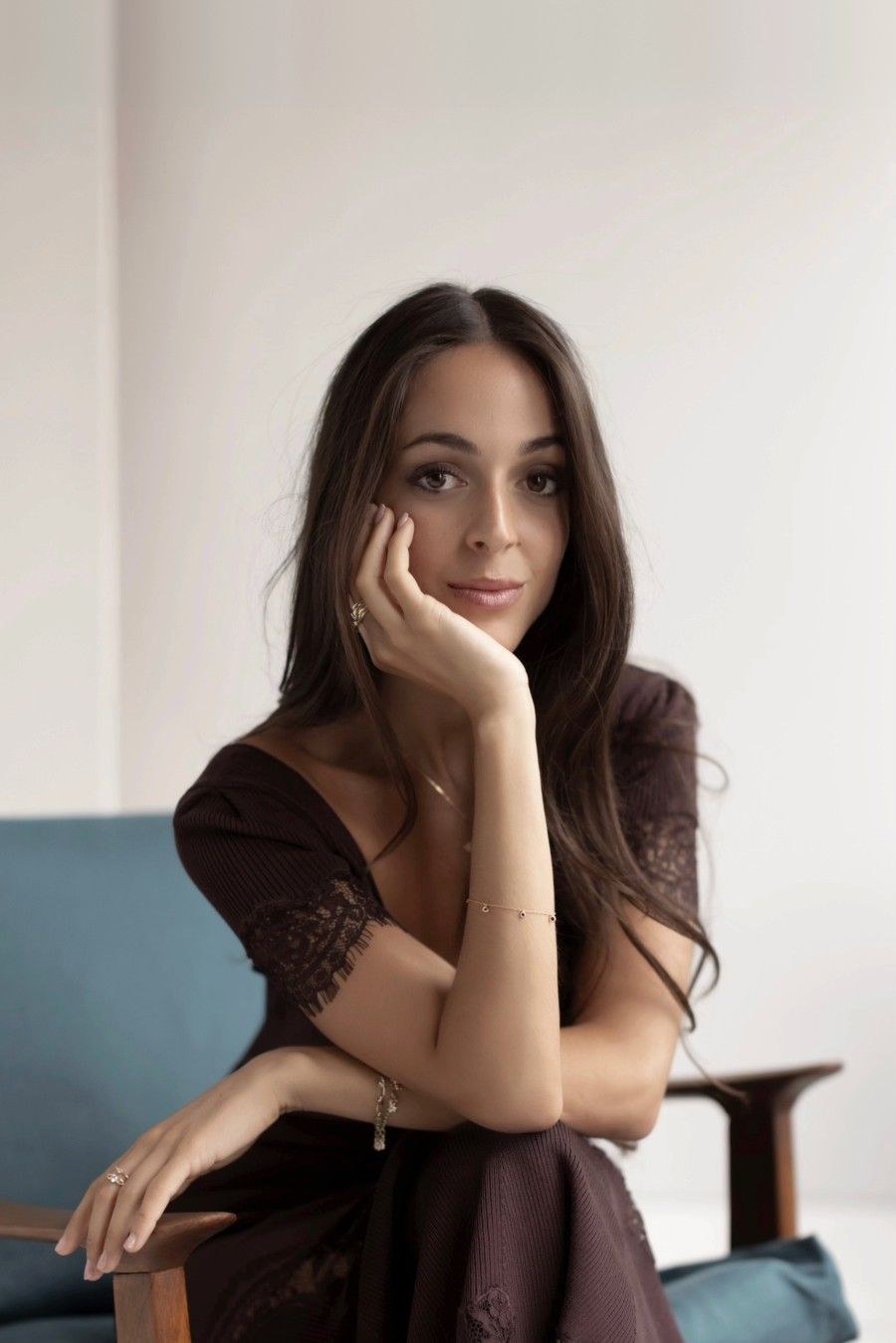 Portrait of Liana Drakopoulou, seated in a teal armchair